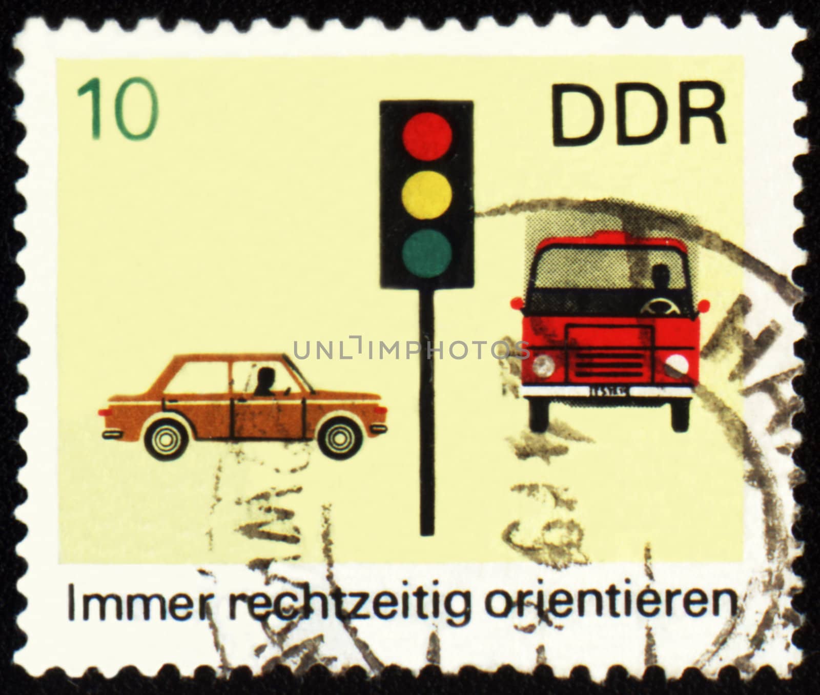 GDR - CIRCA 1960s: a stamp printed in GDR (East Germany) shows car, truck and light signal, devoted to the explaining rules of the road, circa 1960s