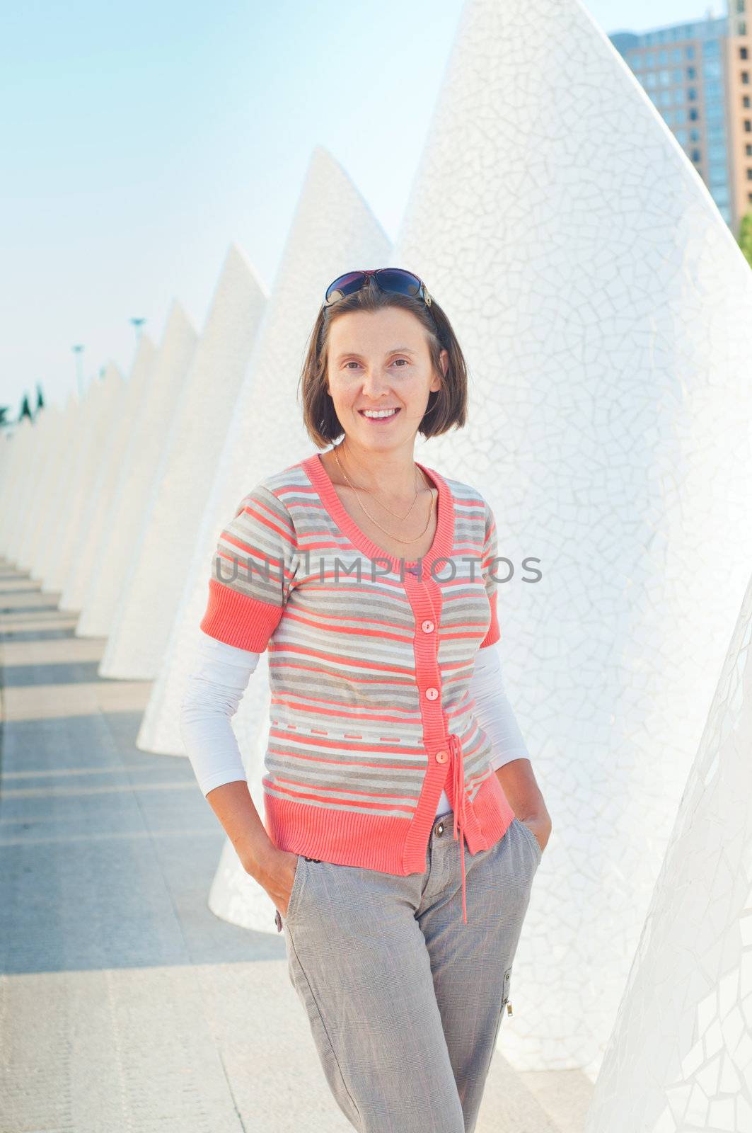 A young woman walking of modern building. Valencia Spain