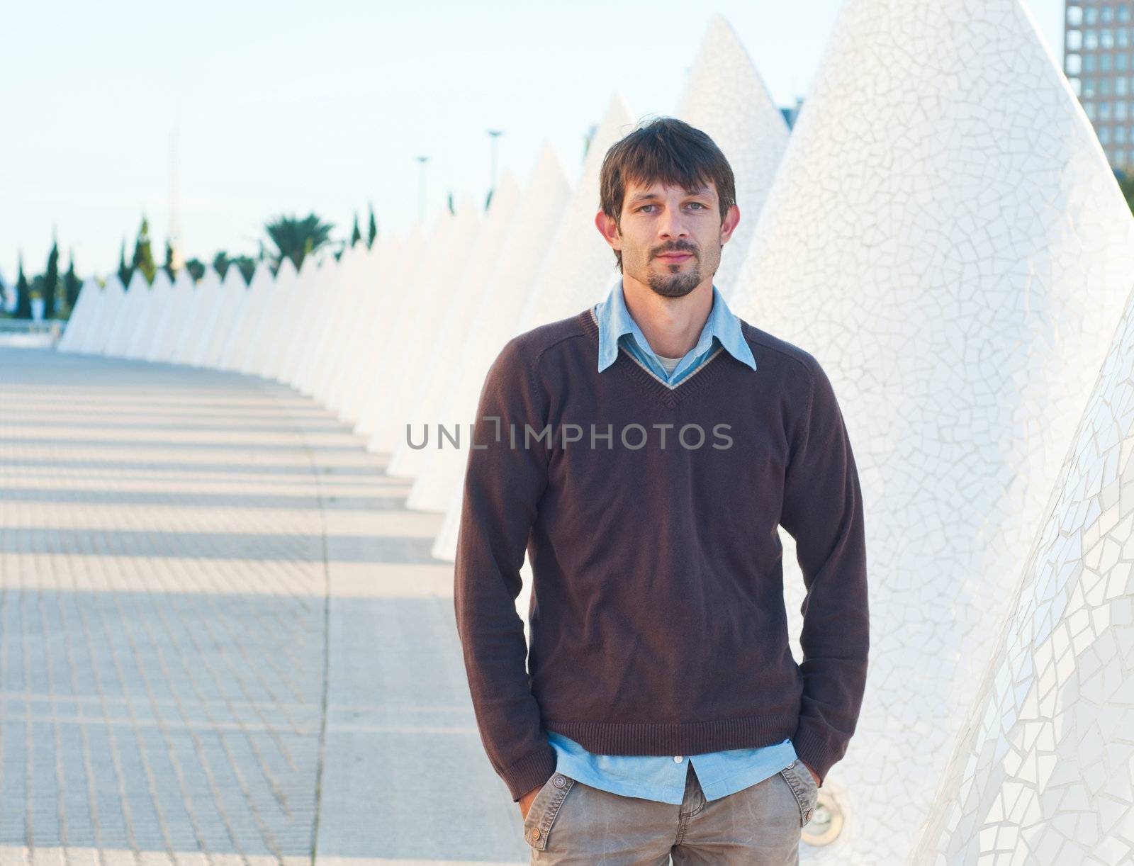 A young man walking of modern building by maxoliki