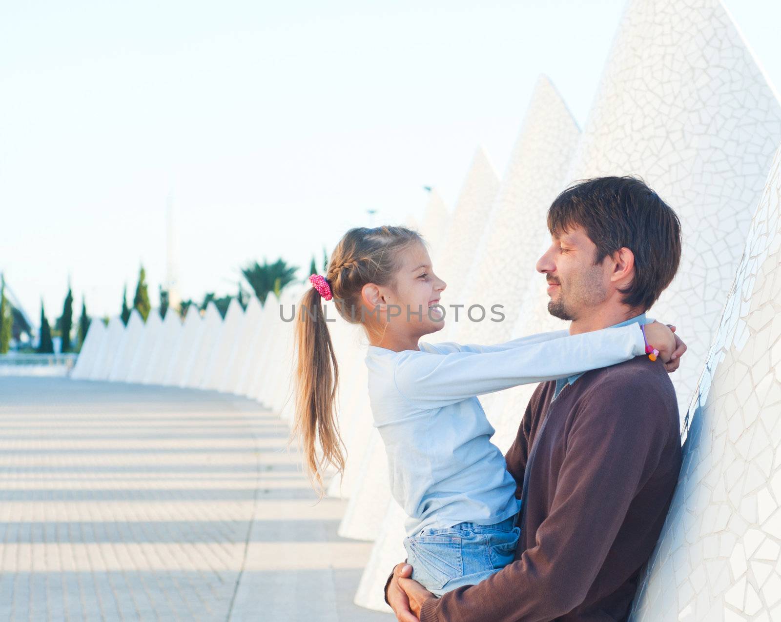 Happy father with his dauther walking of modern building. Valencia Spain