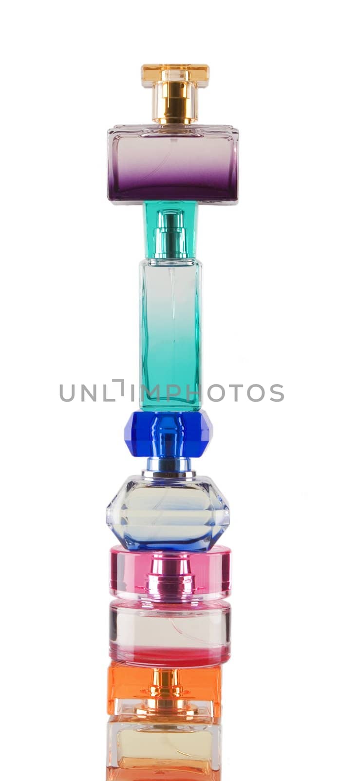 Tower made from perfume bottles on white background