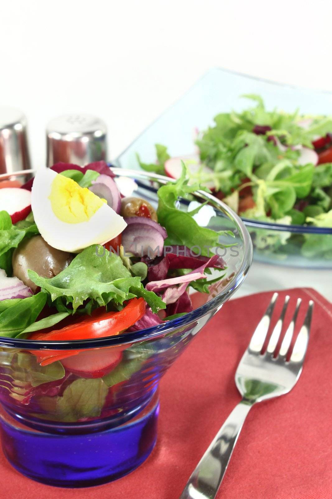 a blue bowl of fresh mixed salad