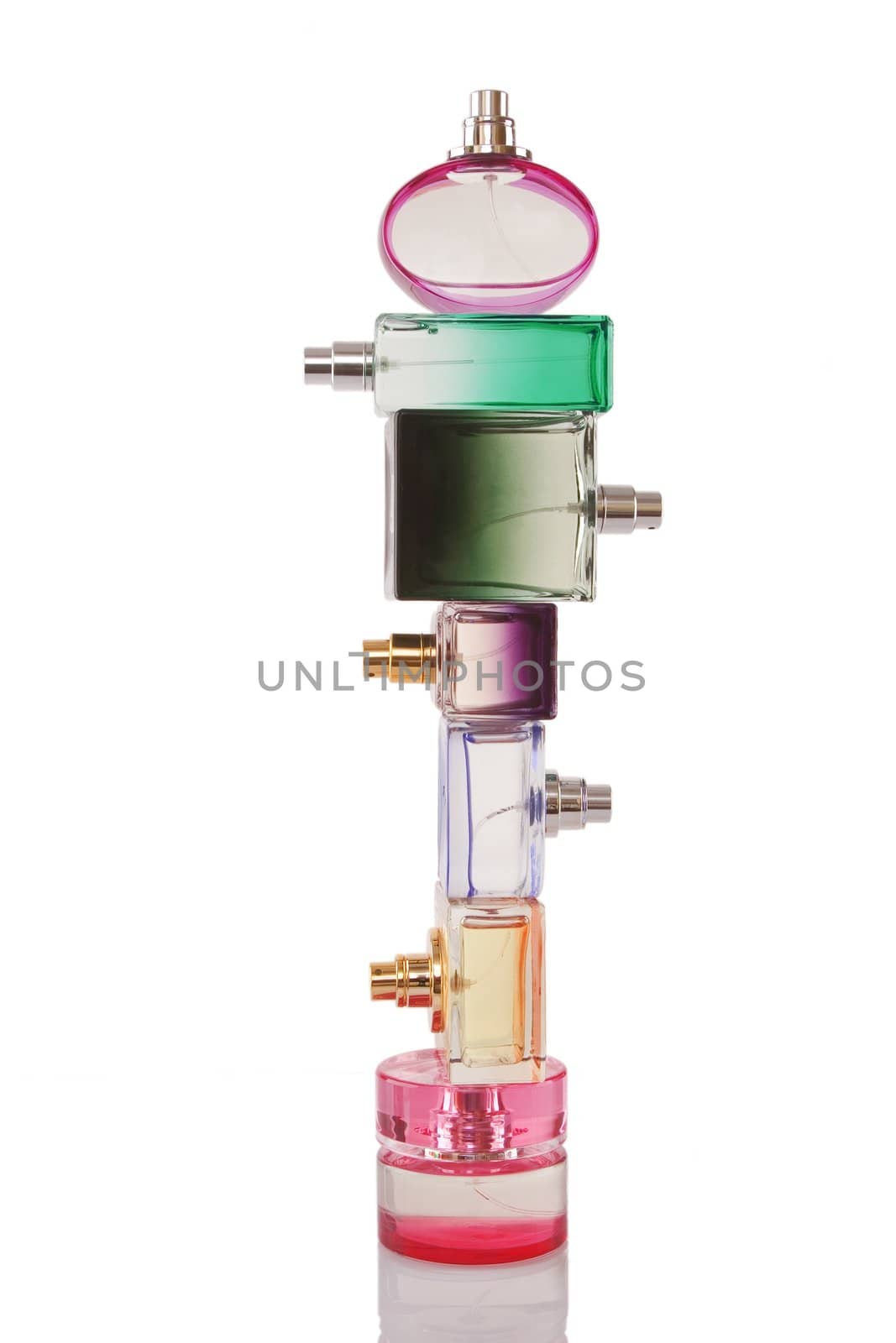 Tower made from perfume bottles on white background