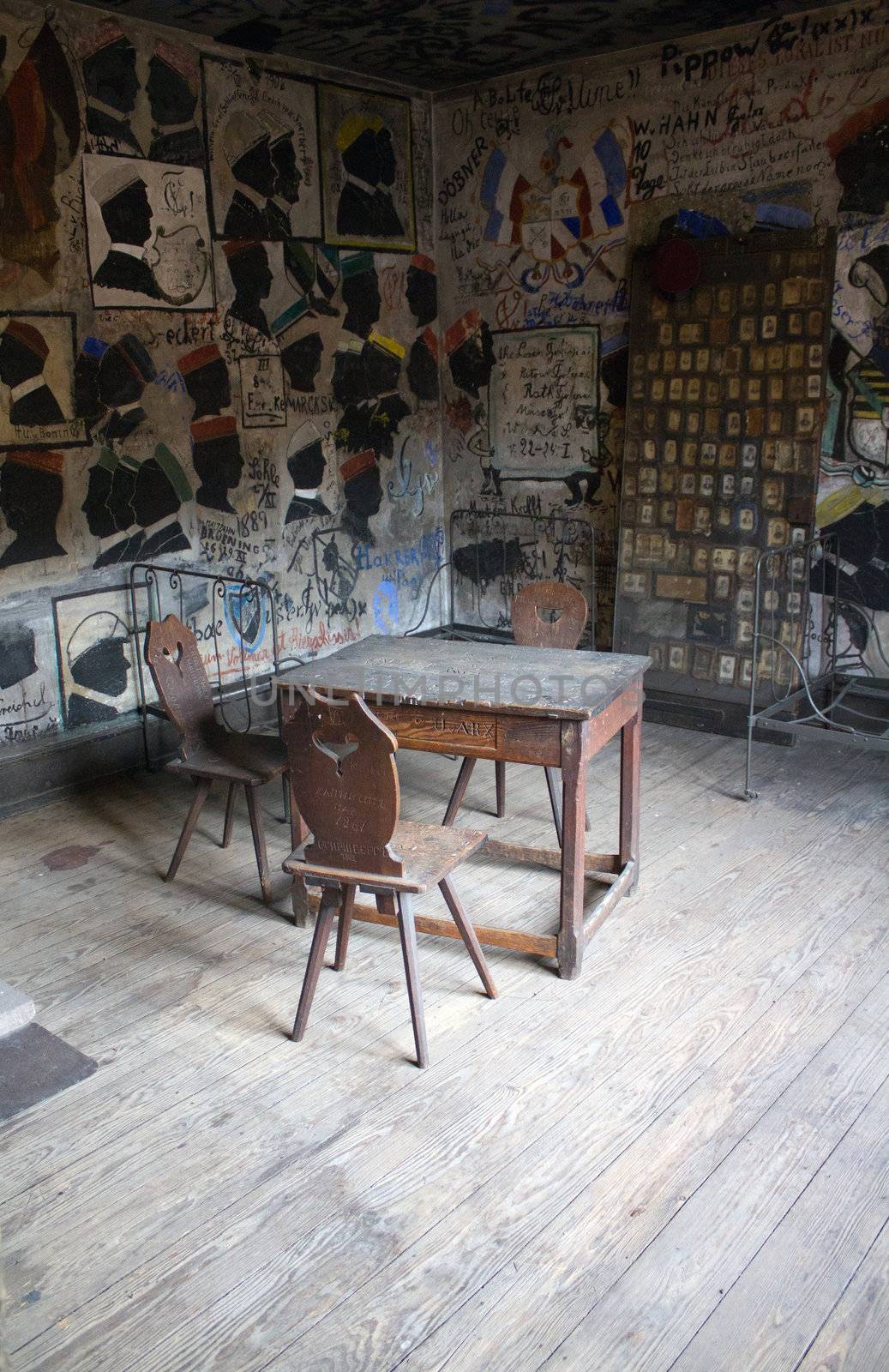 A derelict and grafitied room lays still, illuminated by the setting sun.