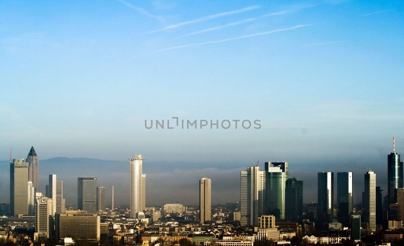 Frankfurt's Skyline illuminated by the morning light and siloutted against the early morning's fog.