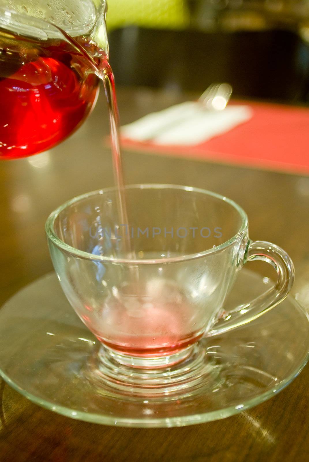 The hot tea pouring to tea cup