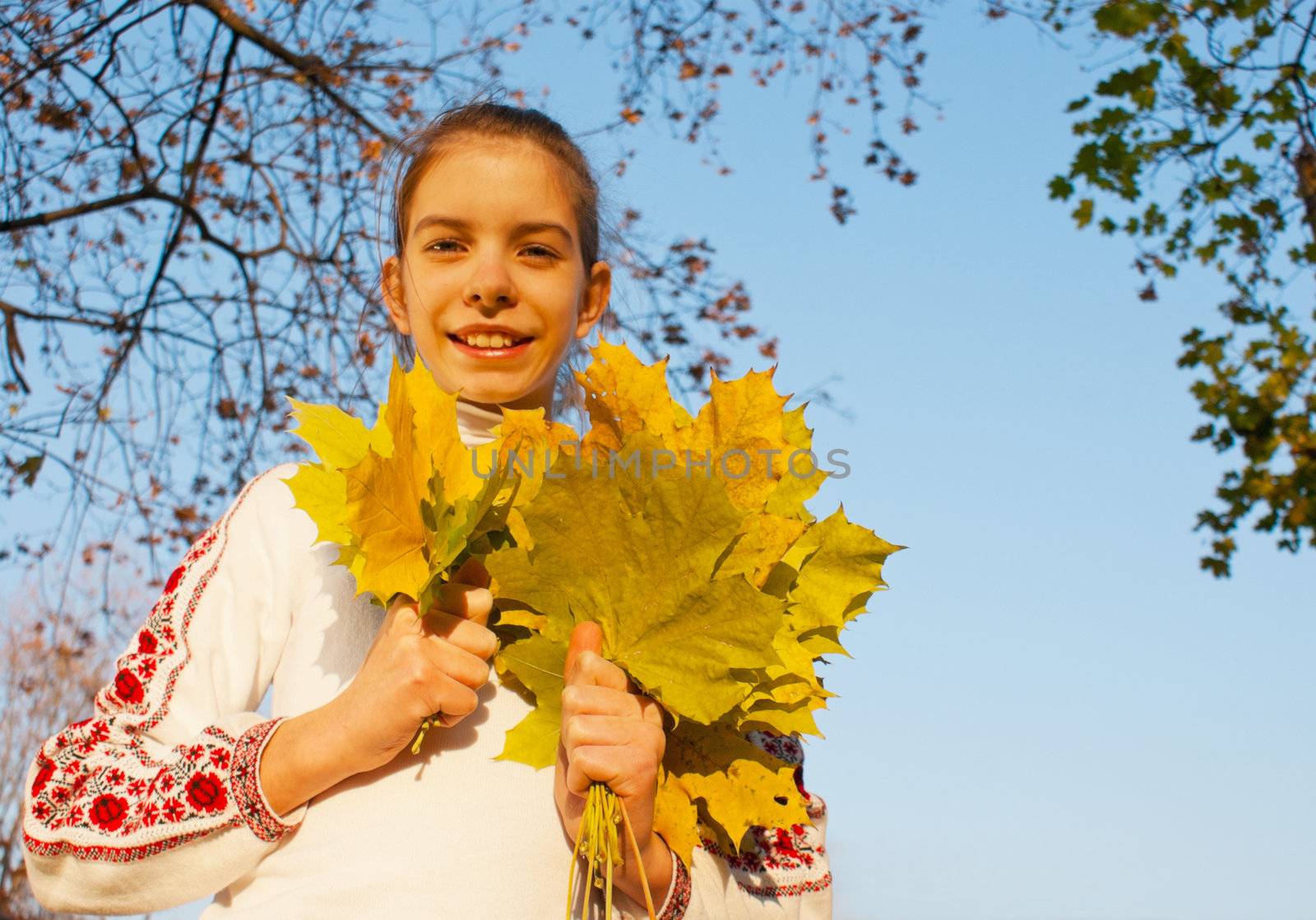 Girl with leaves at fall time by AndreyKr