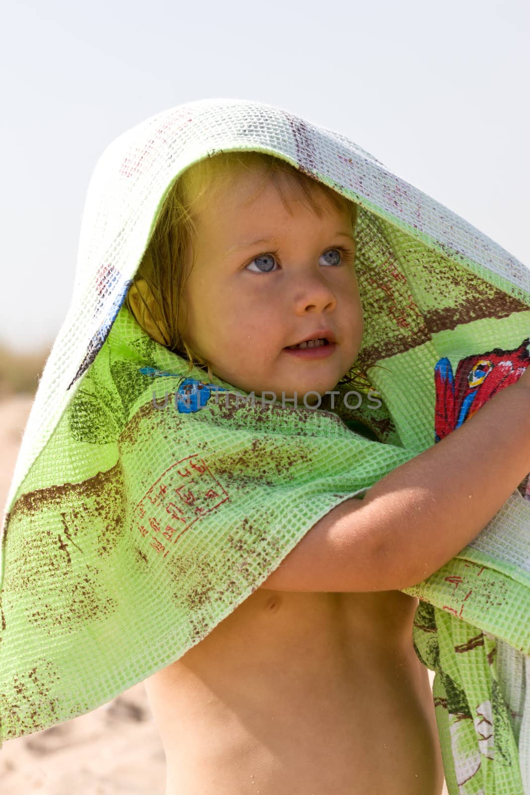 portrait of little girl with green towel