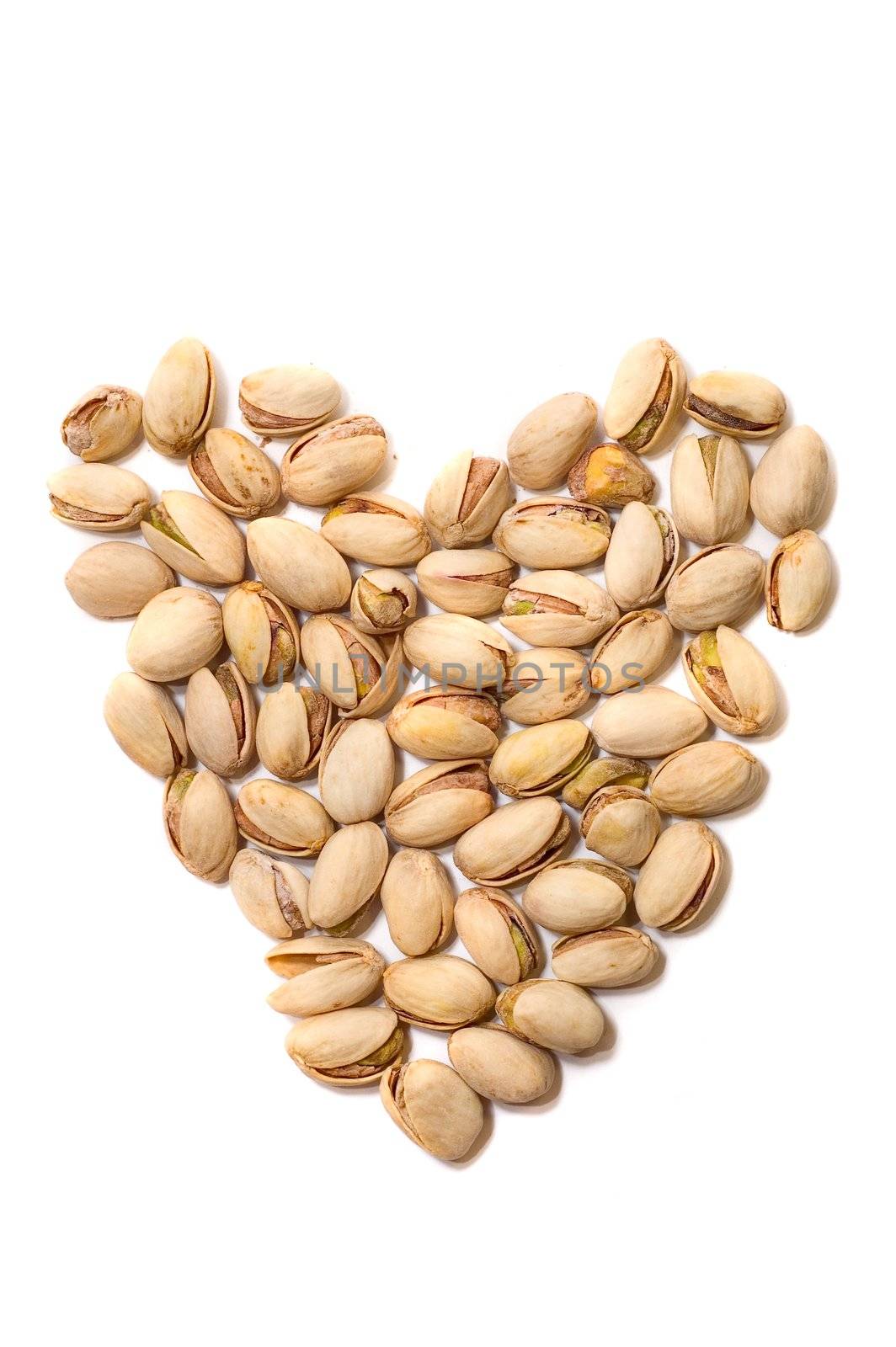 Lots of pistachio as heart isolated on white