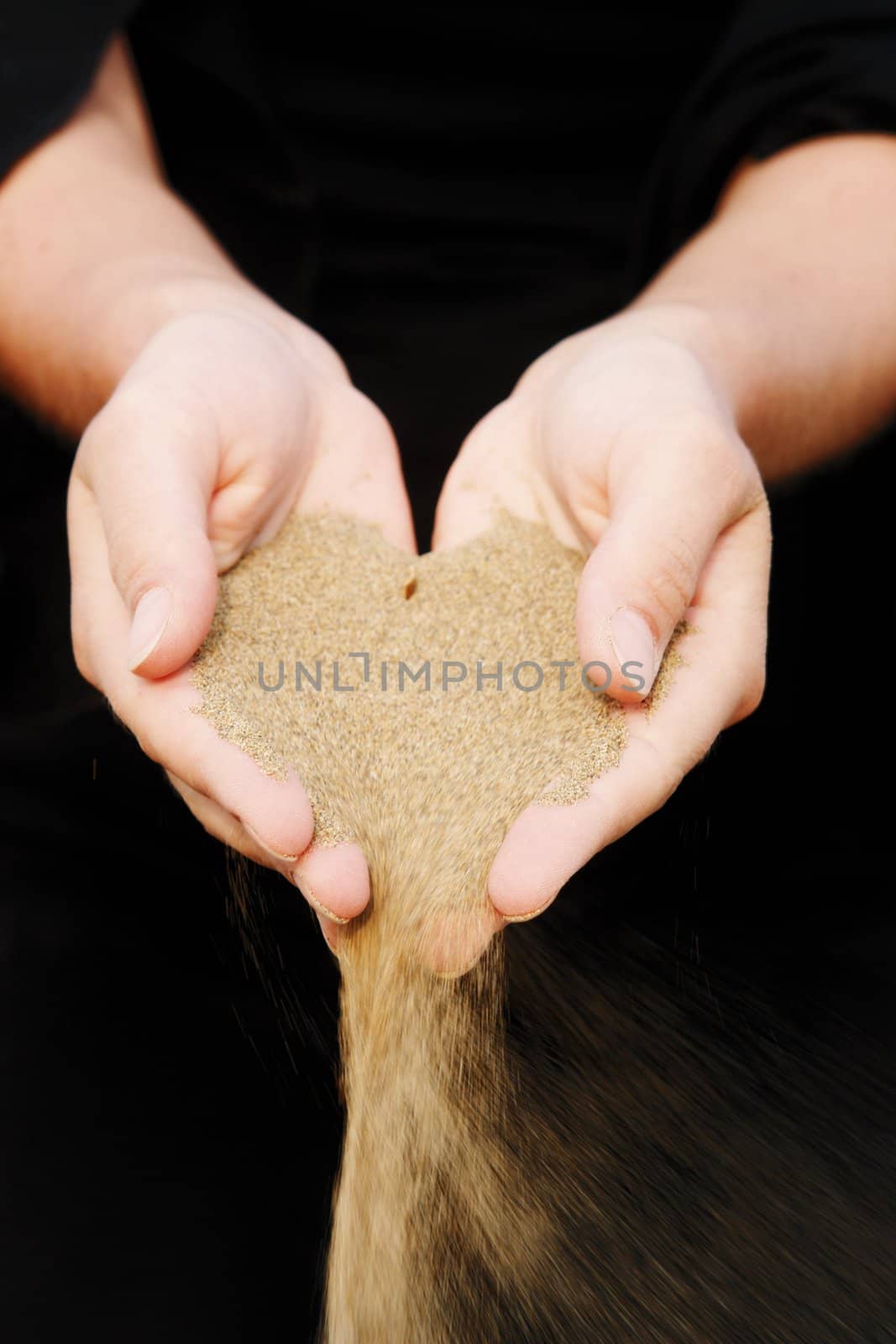 sand running through hands as a symbol for time running, lost etc.............