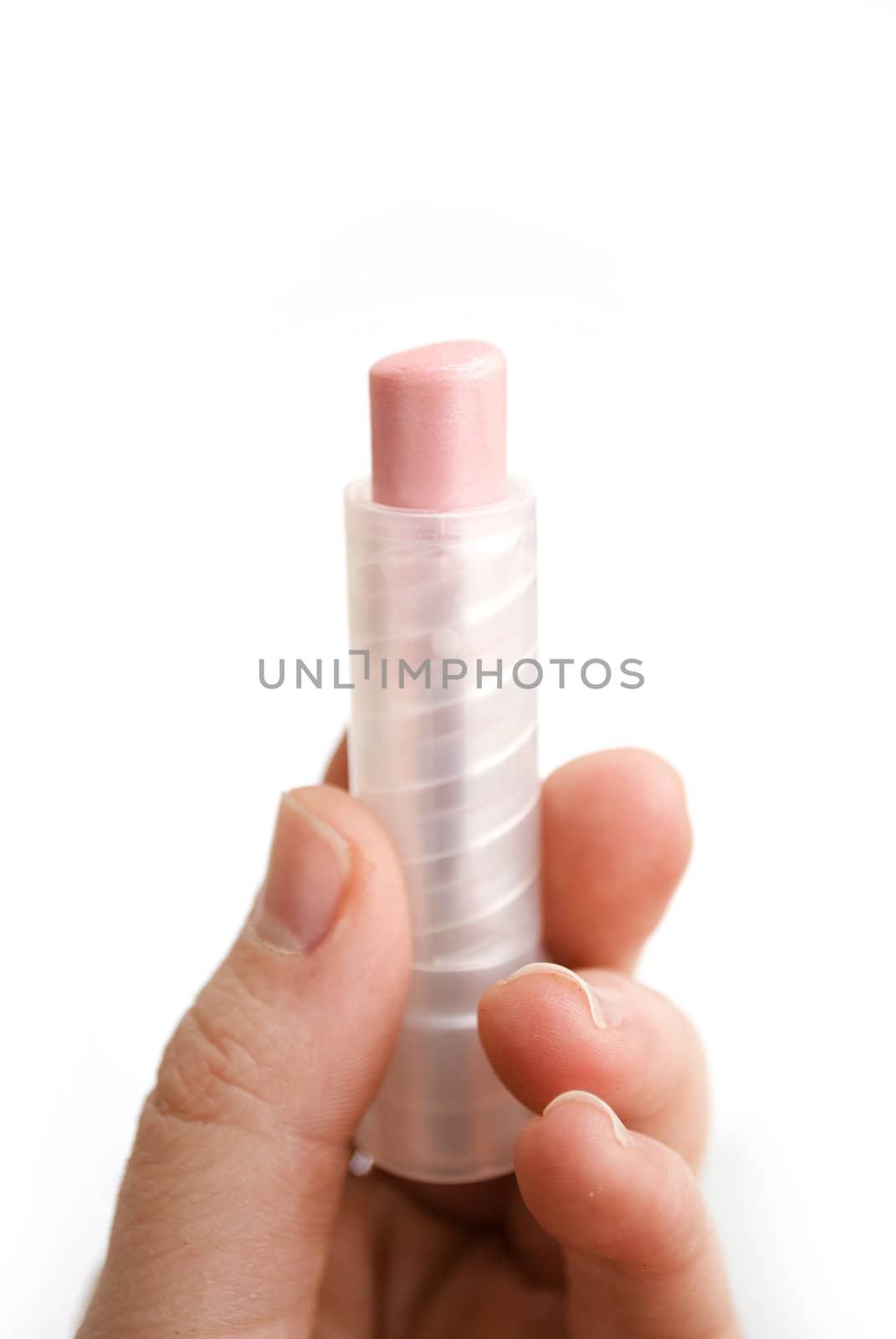female hand holding pink lipstick 