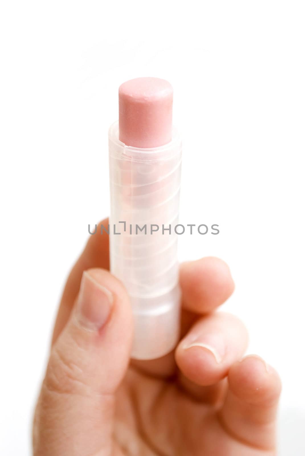 female hand holding pink lipstick