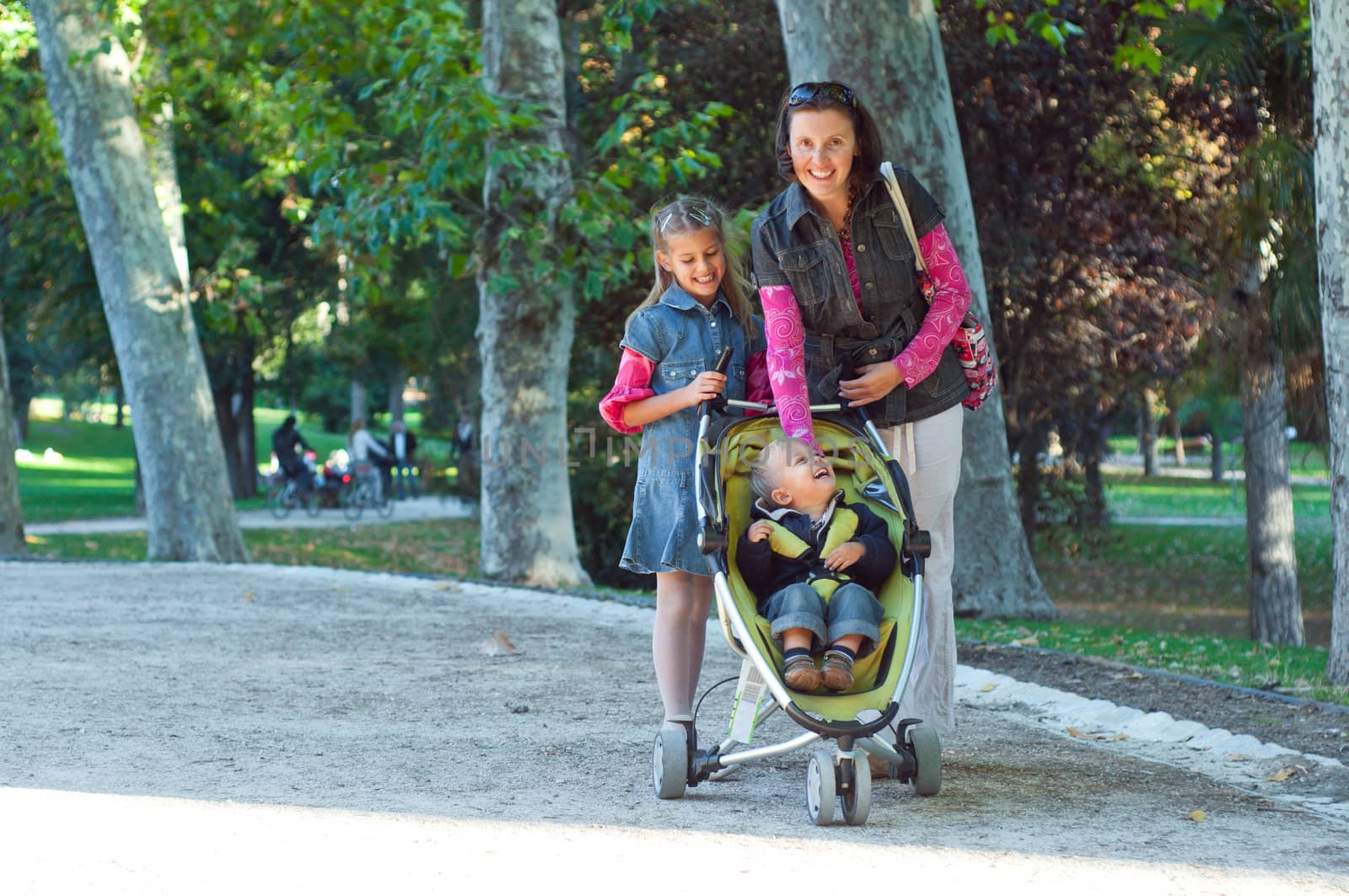 A family walking in the park in the sunny day