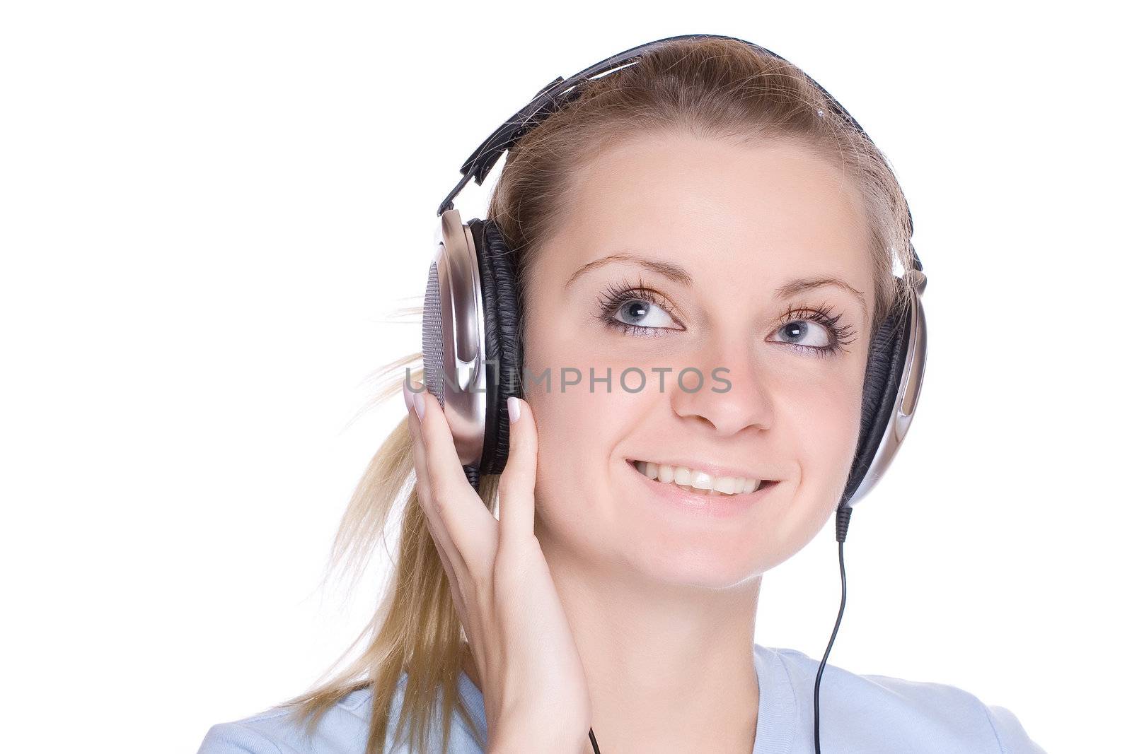 Isolated smiling young girl listening to music