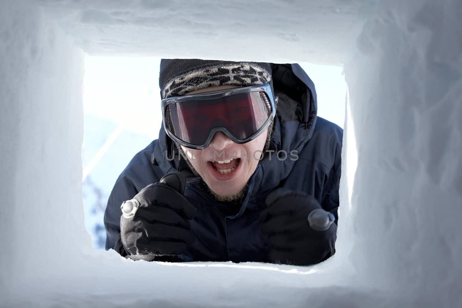 Skier in the window of a hut made of snow