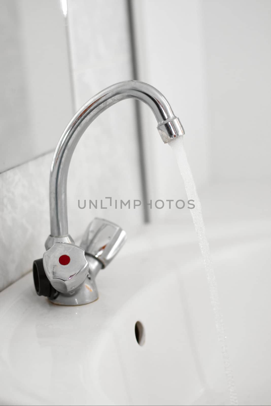 water flowing from the tap in the bathroom