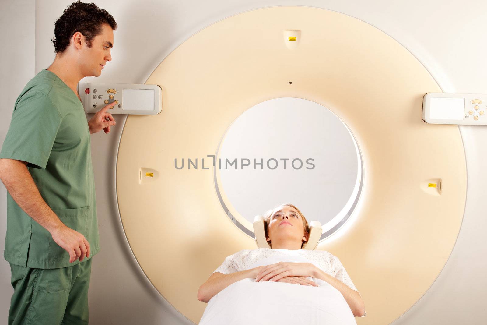 A CT Scanner Technician preparing a patient for scanning
