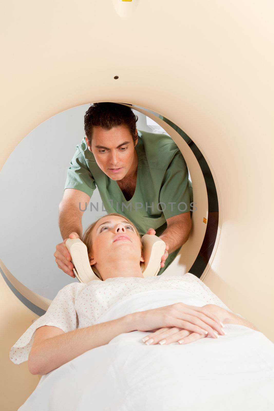 A young woman having a CT scan taken - Nurse getting things prepared