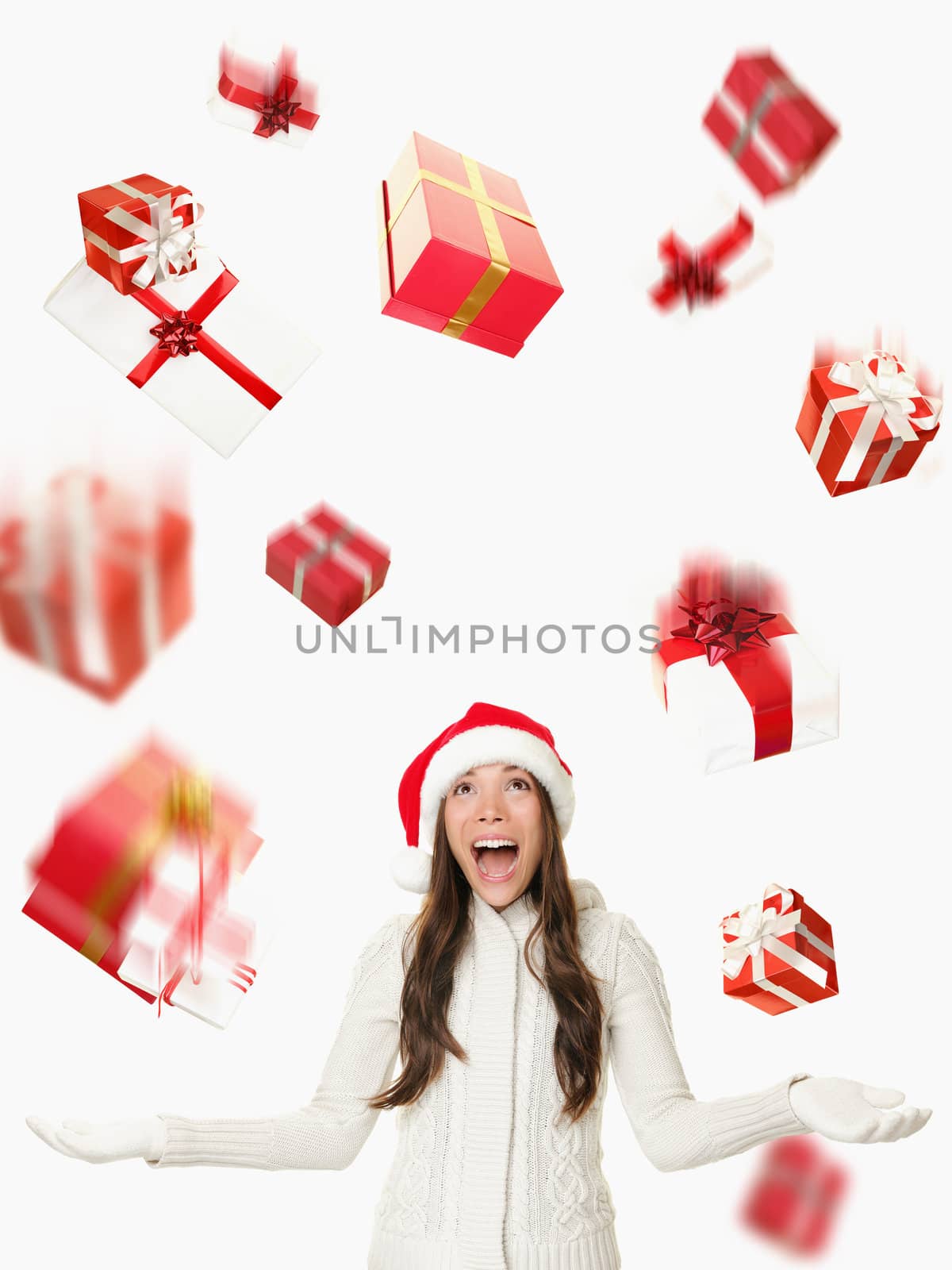 Christmas Santa woman - raining gifts and falling presents. Asian woman in santa hat excited isolated on white background.