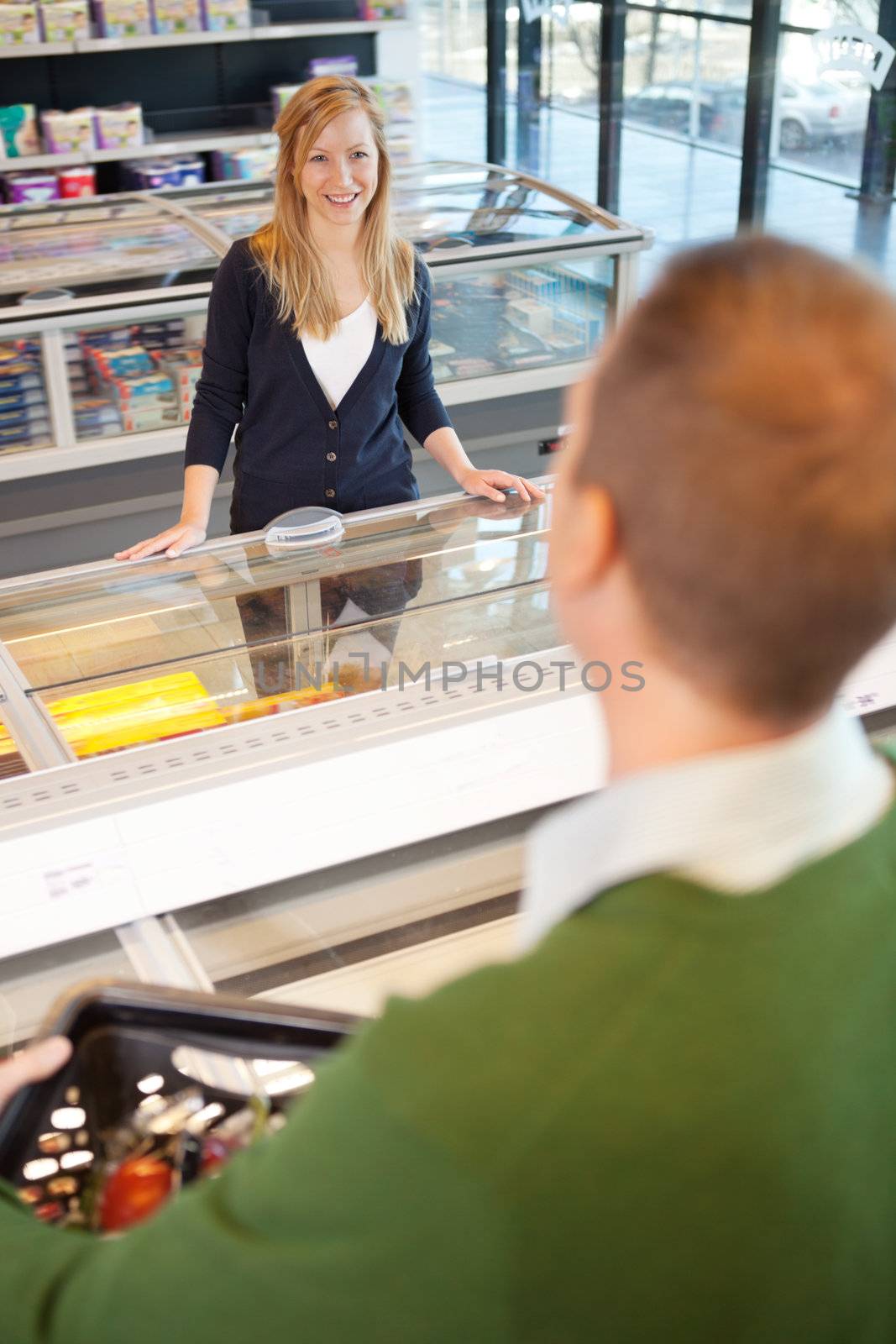A woman flirting with a man in a grocery store