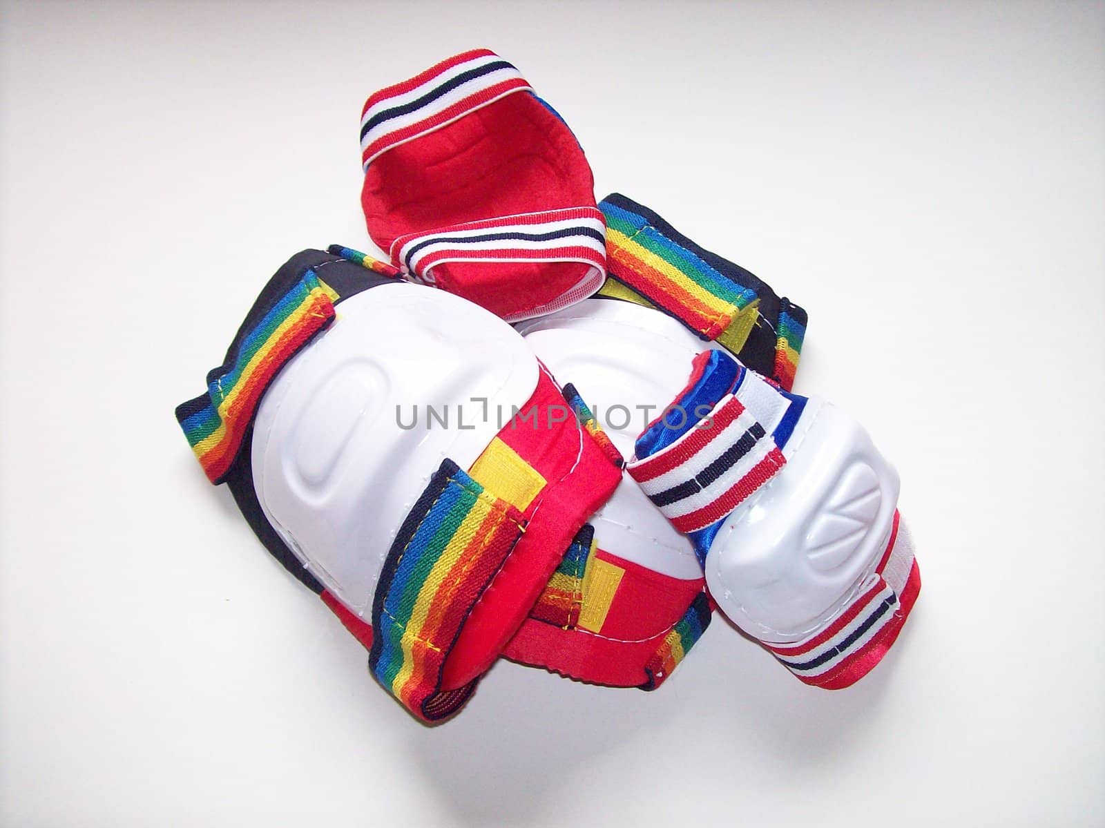 Elbow and knee pads in a pile over a white surface