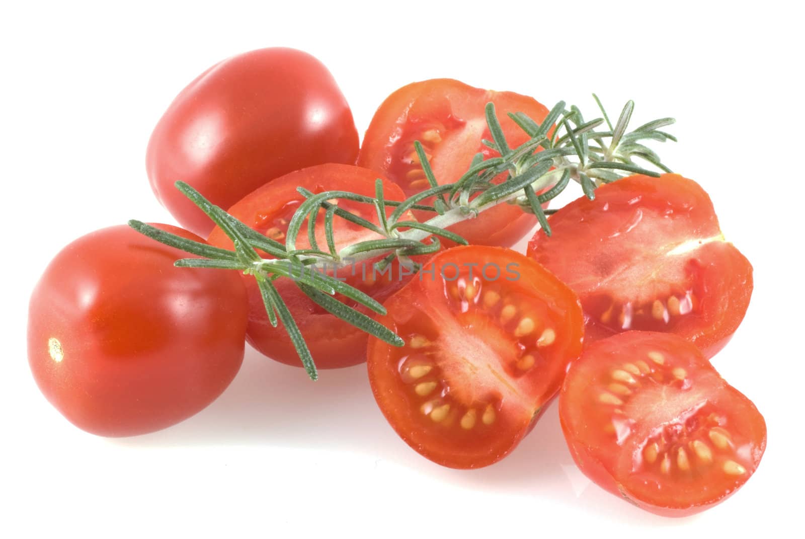 Cherry tomatoes and a thyme branch on a white background.