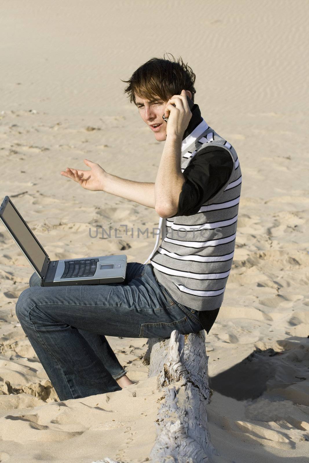 Young professional working on the beach talking to a client