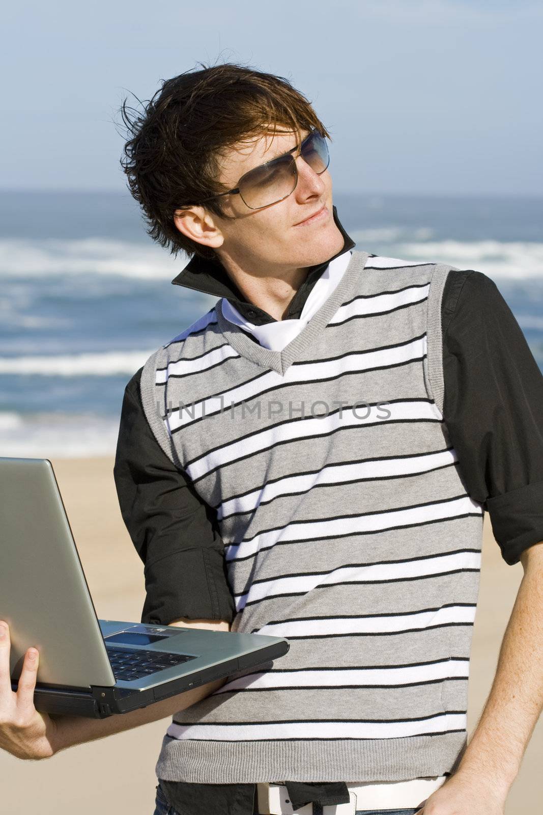 Young male professional working at the beach 