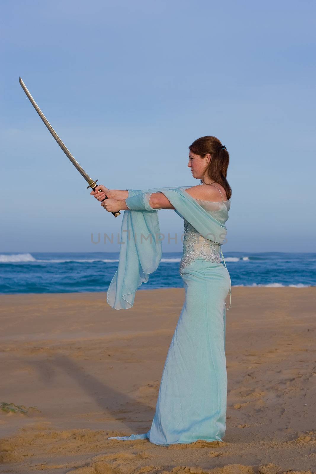 Attractive female model holding a samurai sword