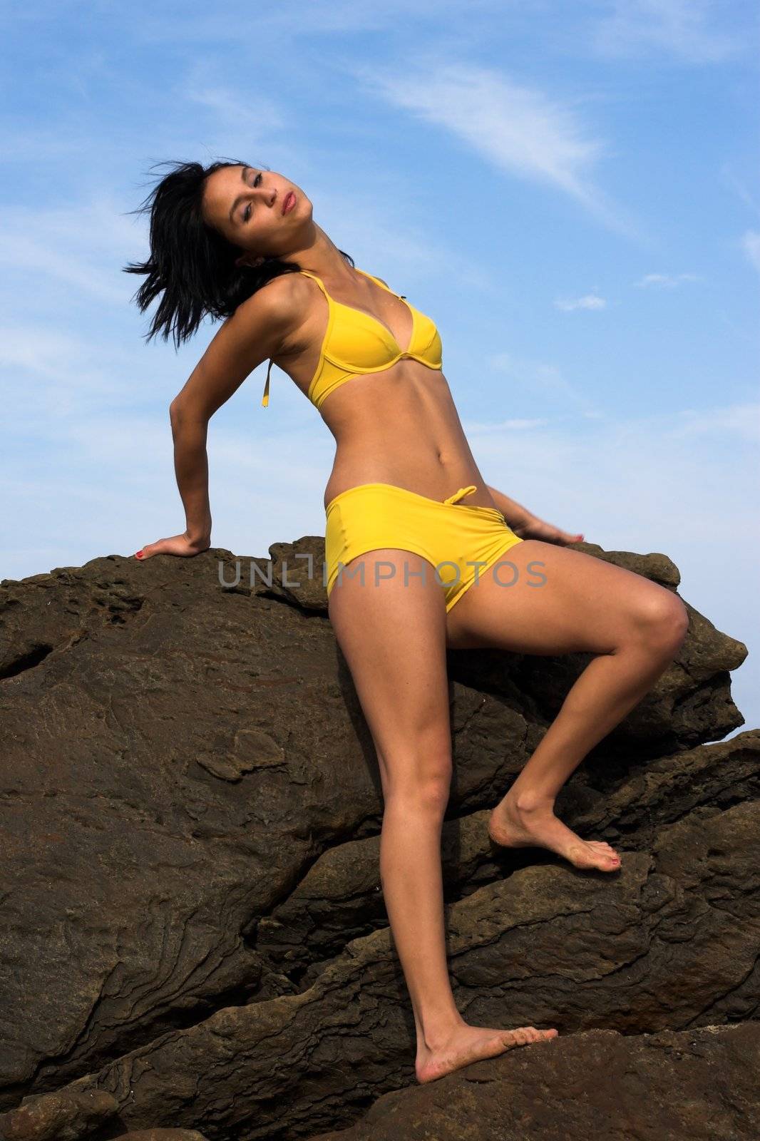Girl on Rock in Yellow Bikini