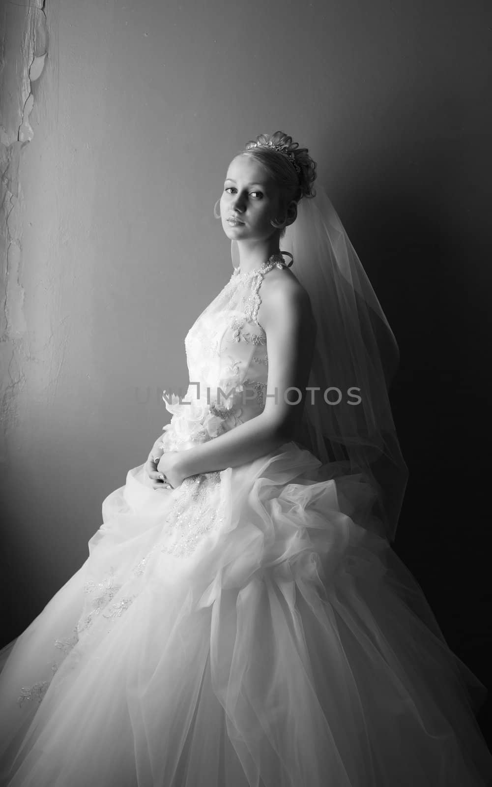 Beautiful bride in dress with flowers. b/w