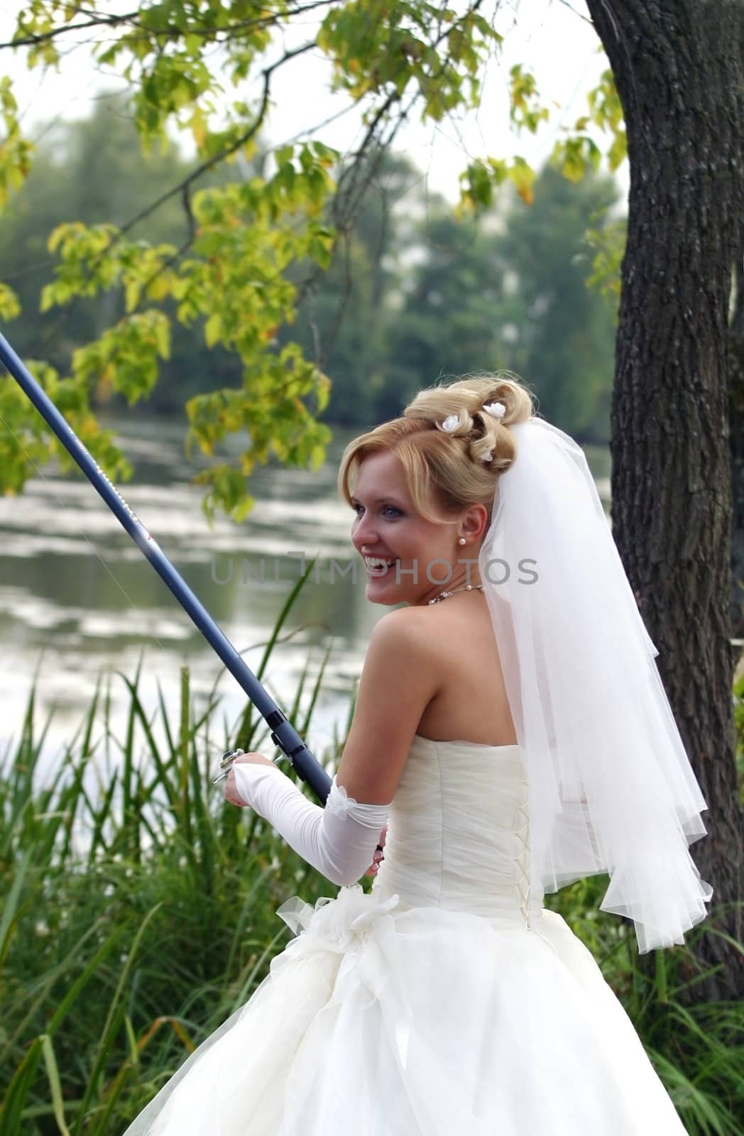 The beautiful bride with fishing tackle