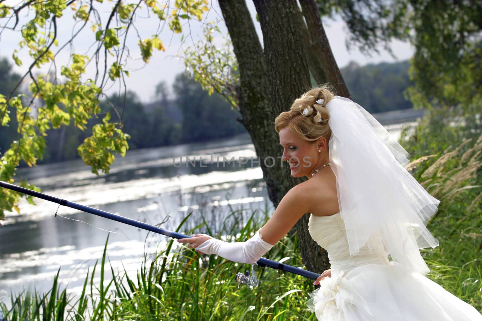 The beautiful bride with fishing tackle