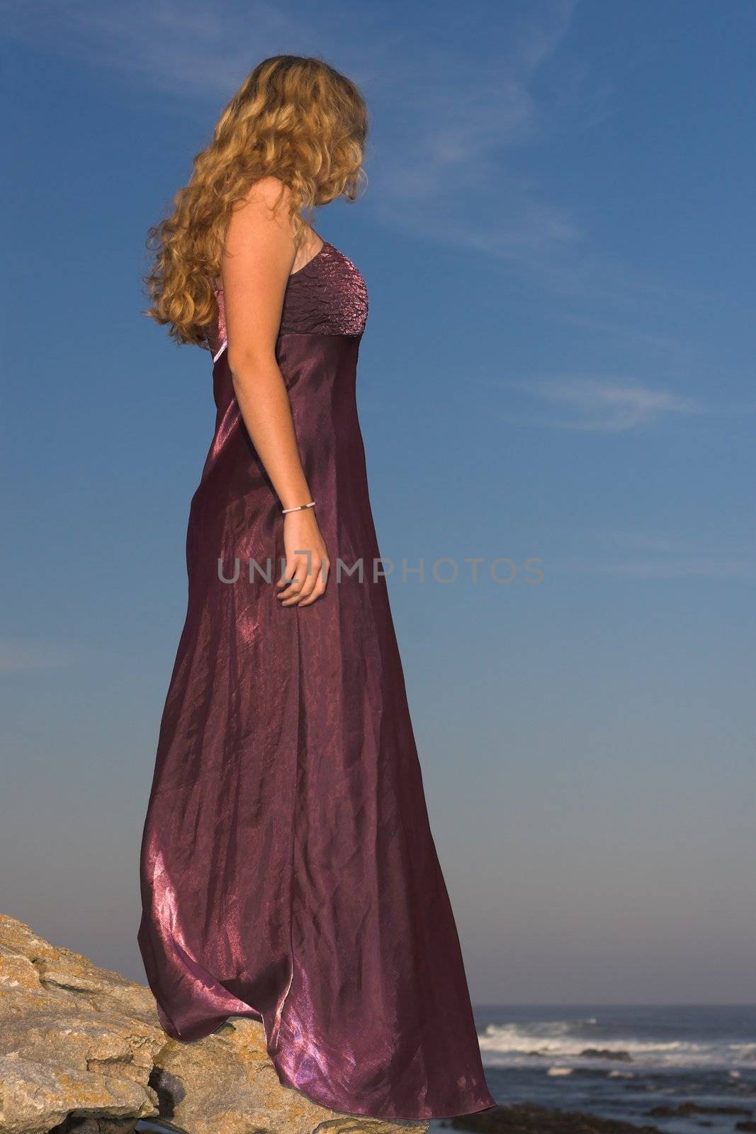 Girl in purple dress at the beach