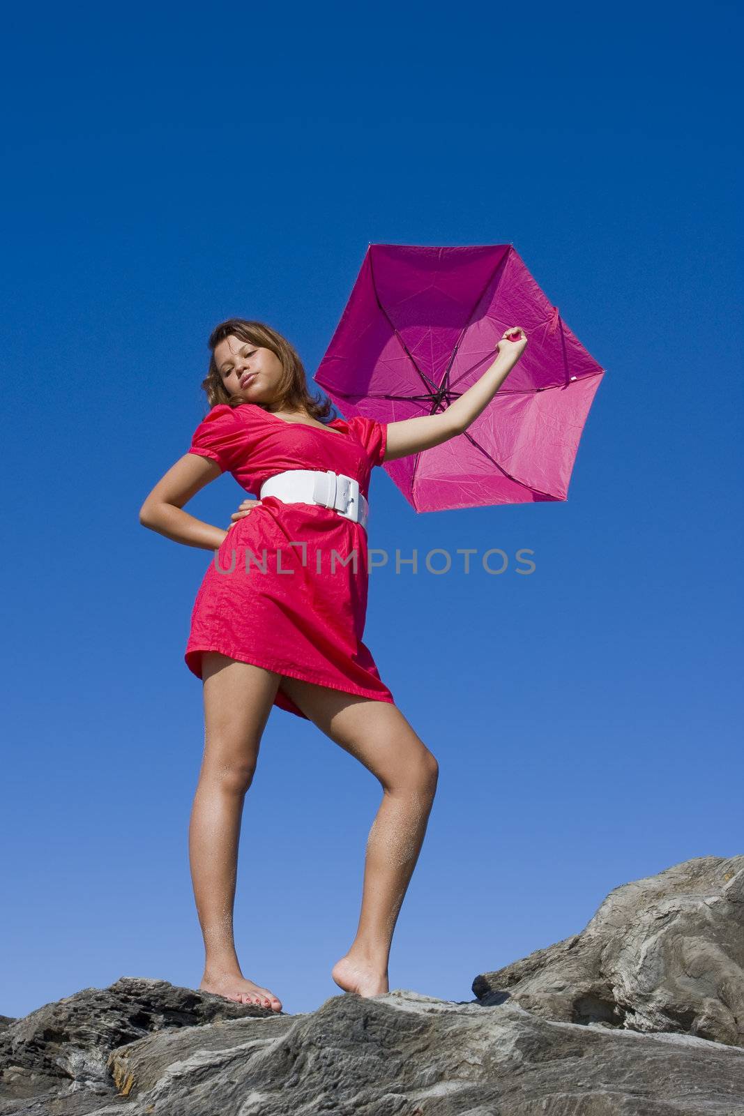 Girl in bright pink dress with bright pink umbrella