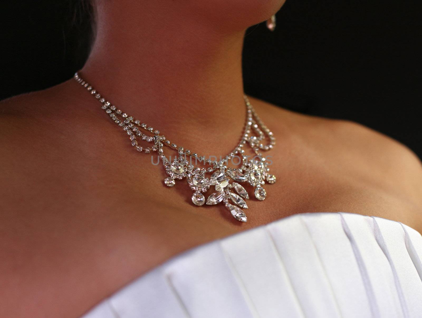 Wedding diamond necklace on a neck of the bride