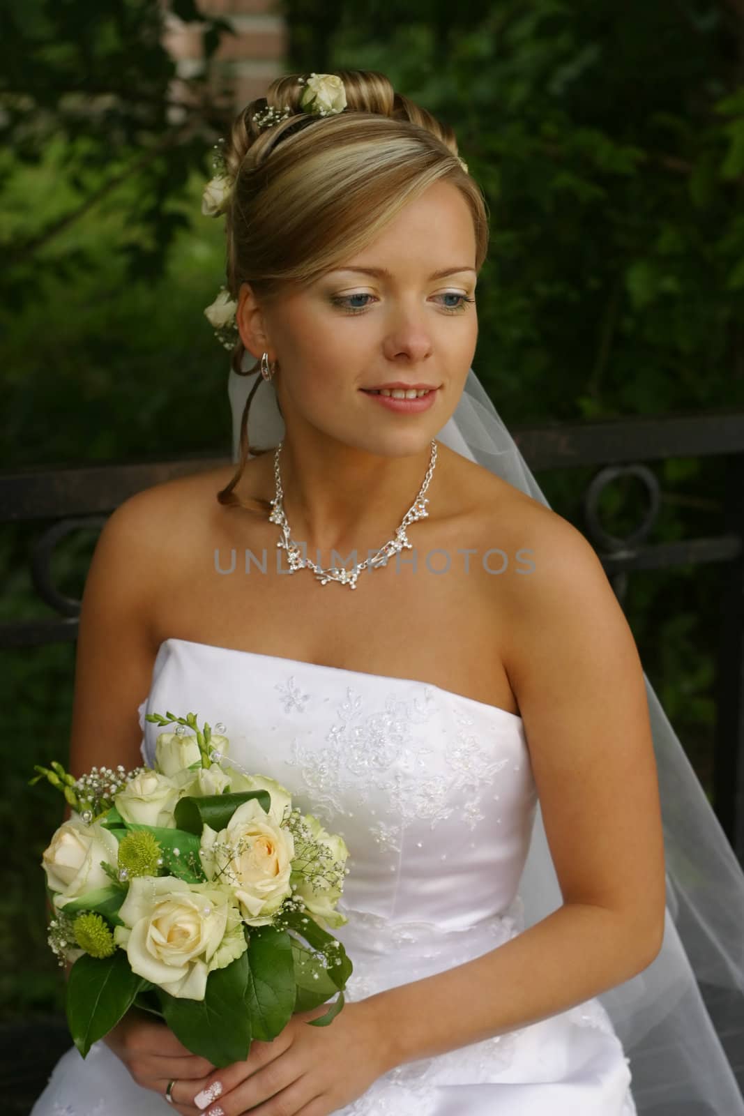 Portrait of the beautiful bride with a bouquet
