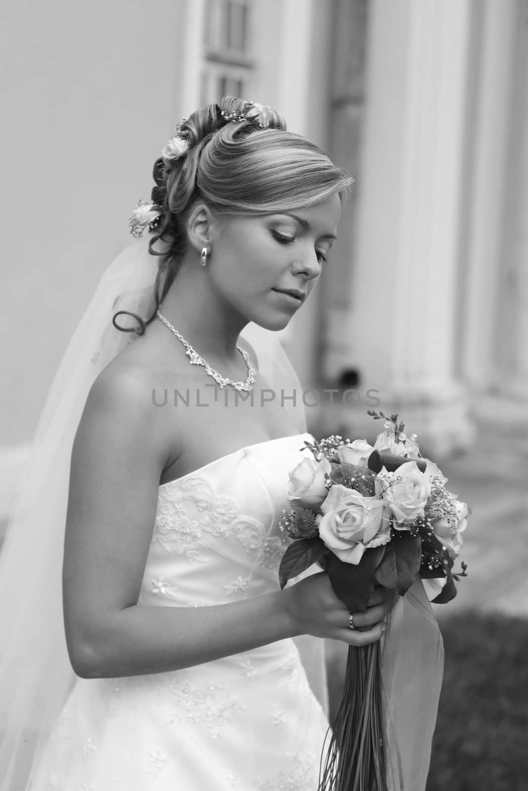 The beautiful bride with a bouquet from roses. b/w