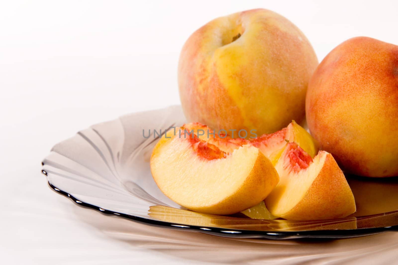 Slices of juicy peaches on white background