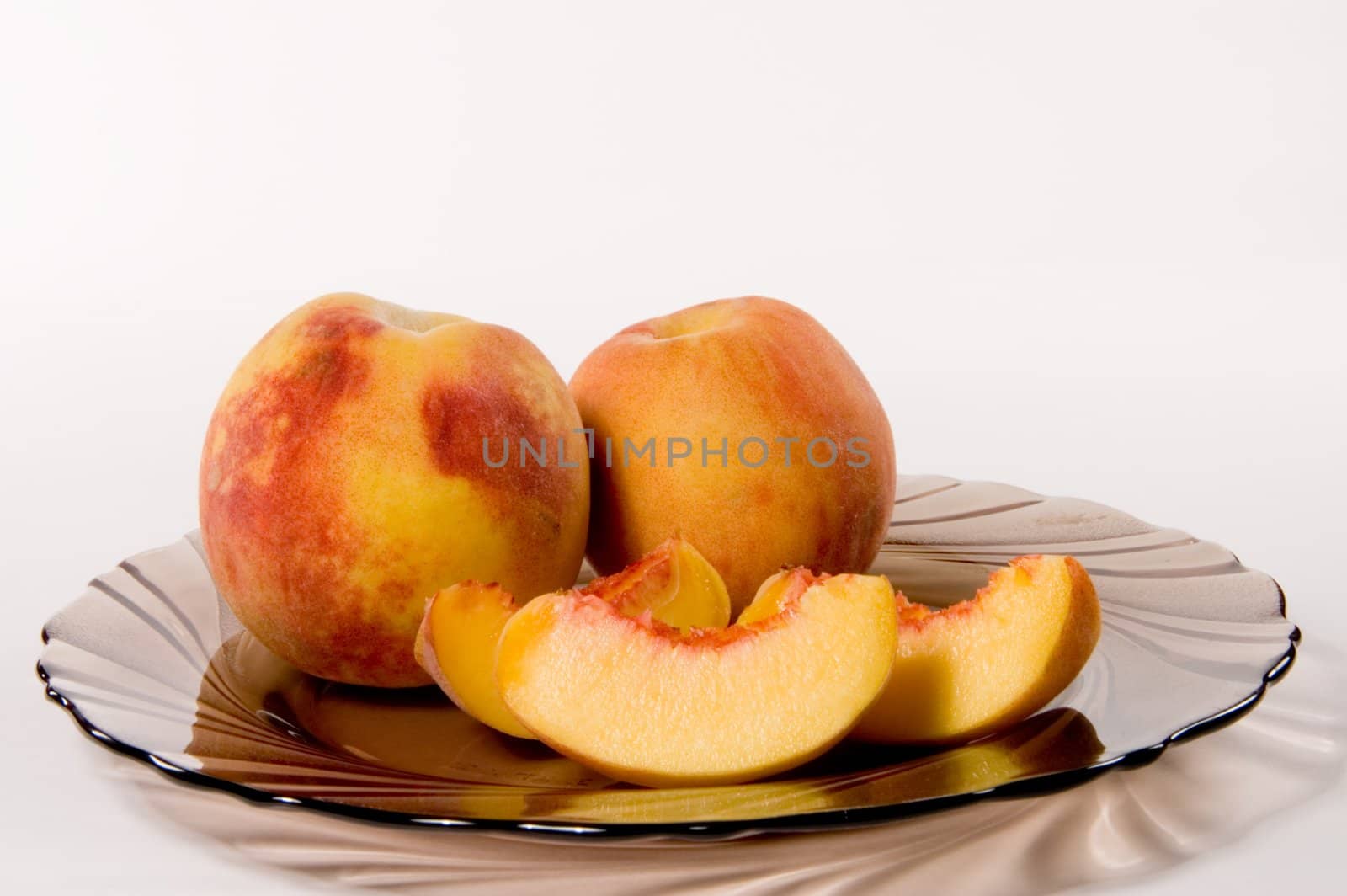 Slices of juicy peaches on white background