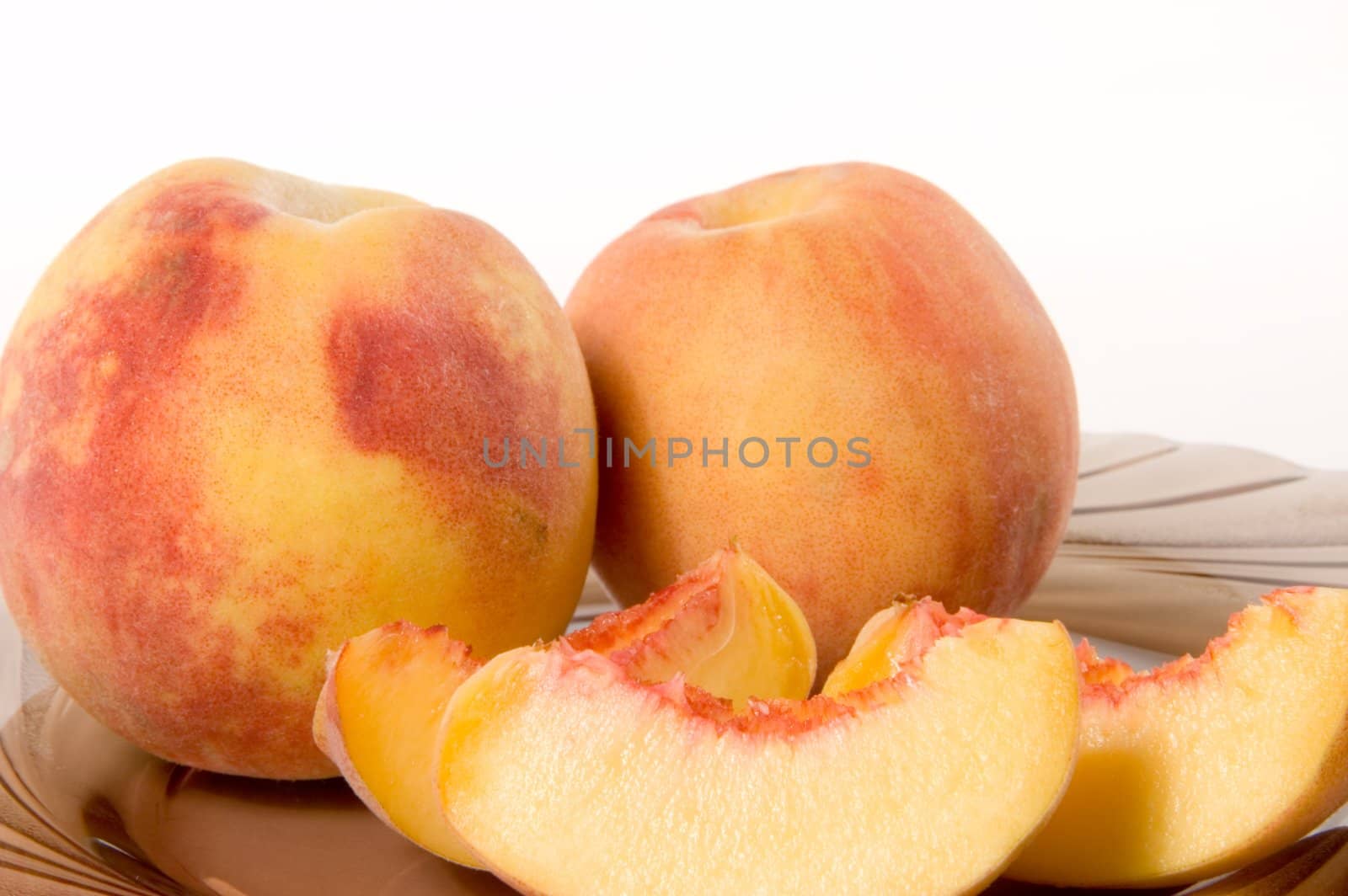 Slices of juicy peaches on white background