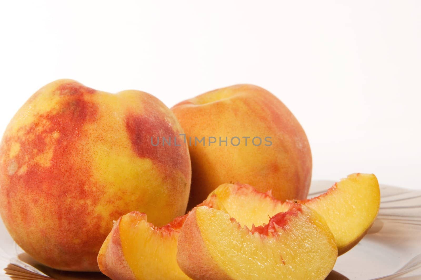 Slices of juicy peaches on white background