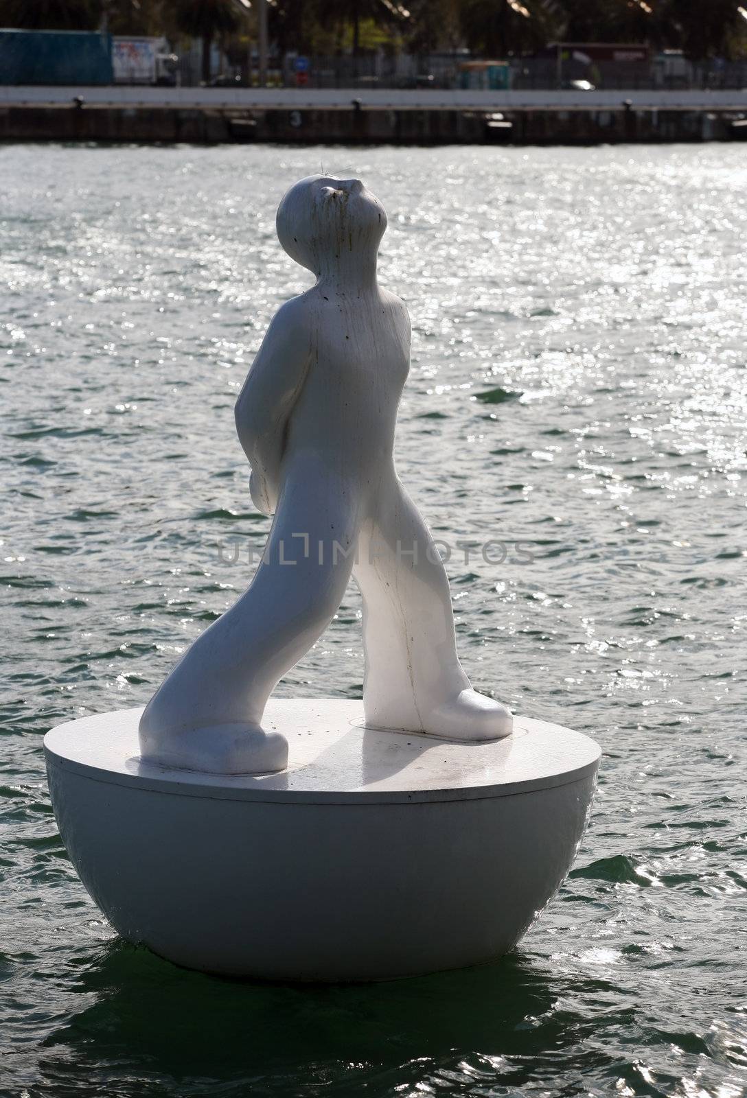 White buoy shaped like a man in Port Vell, Barcelona