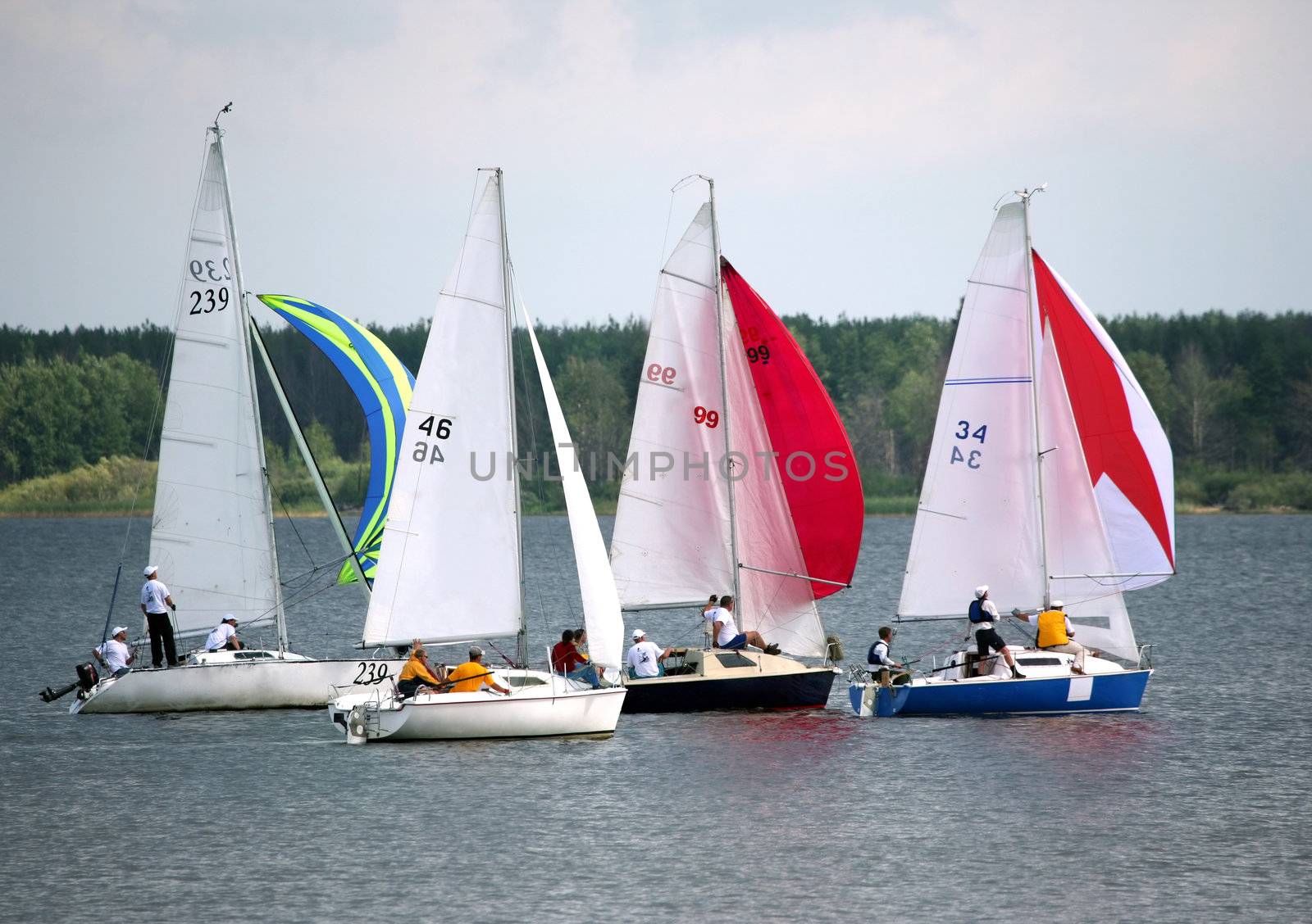 Four sailing boat at an open river. Competitions in Russia