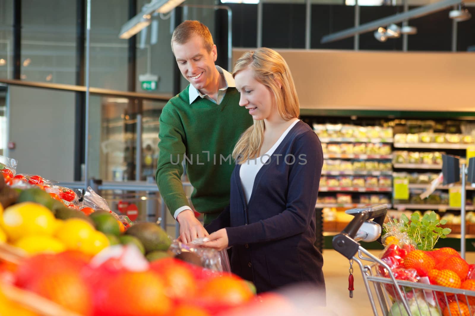Man and woman looking at products and smiling in shopping store