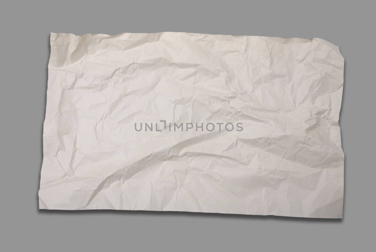 Old crumpled paper on gray background  by pixbox77