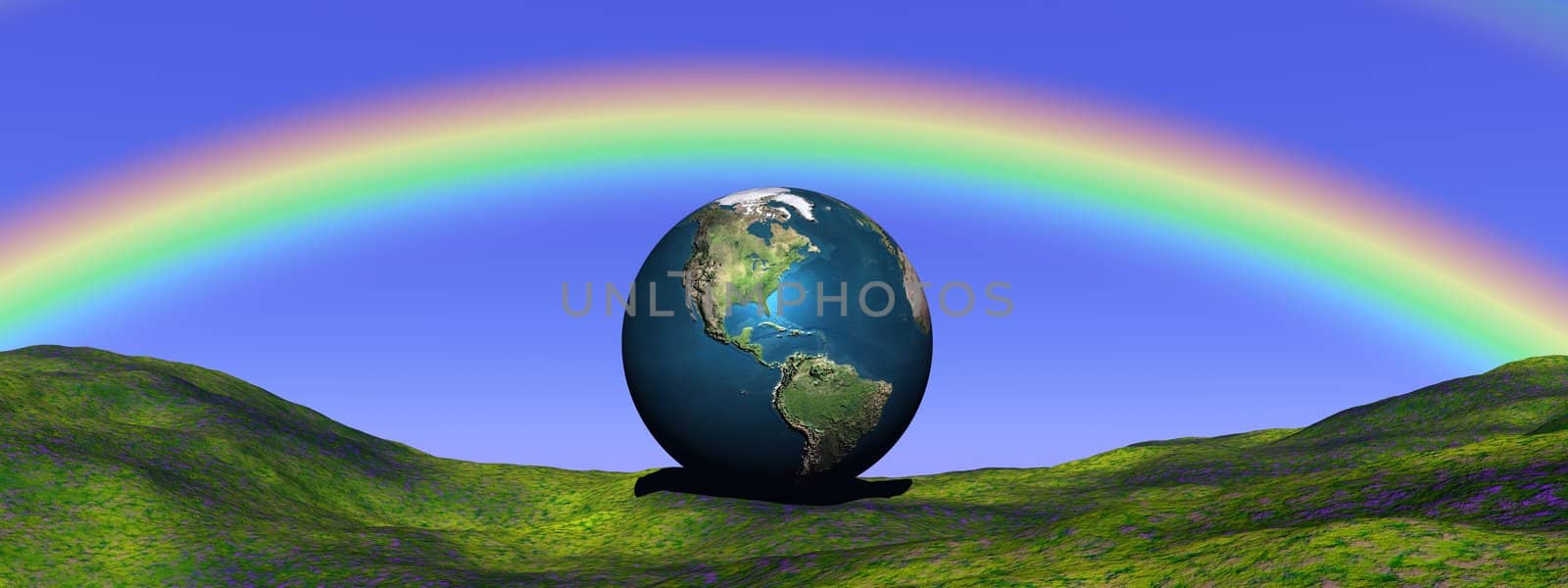 Earth planet on a green grass hill and under a beautiful rainbow