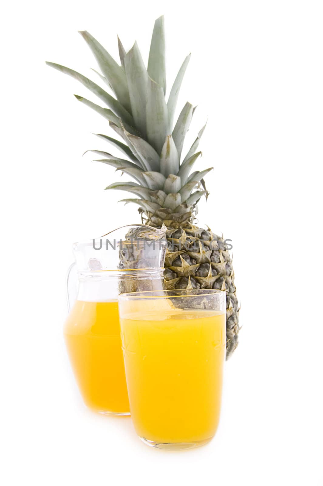 Pineapple juice in jug and glass with fruit isolated
