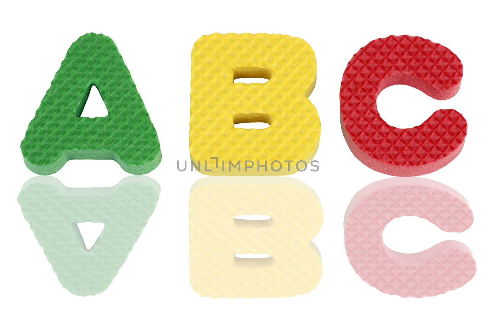 Fun colorful A B C alphabet letters in green, yellow and red textured foam with reflections.