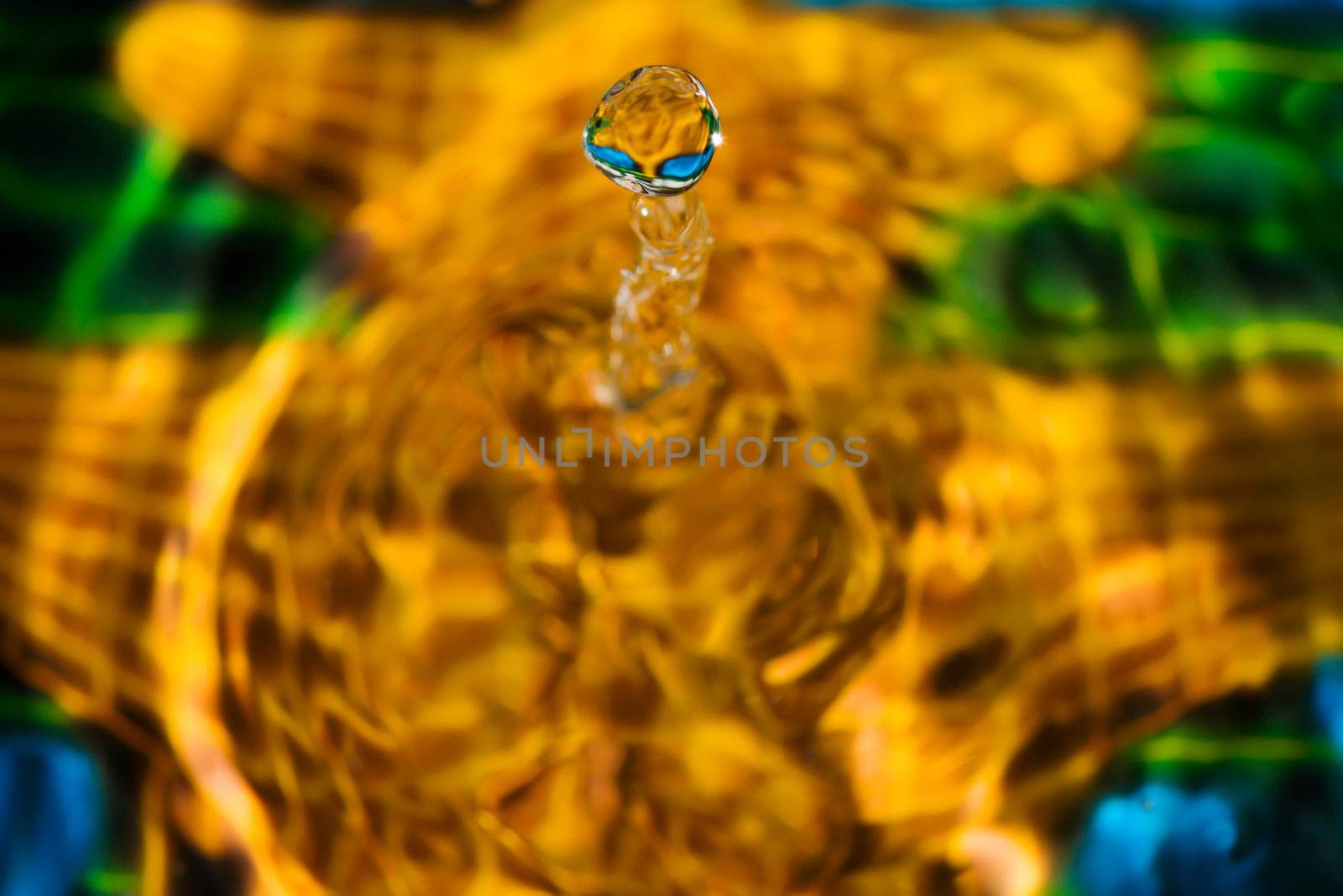 Close ups of water drop sculptures on a colorful background.